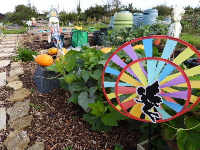 A plot with windmill and scarecrows.